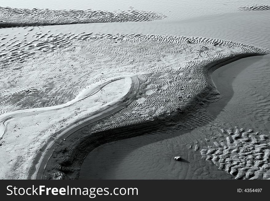 Interesting curves of sand dunes on the withered coast