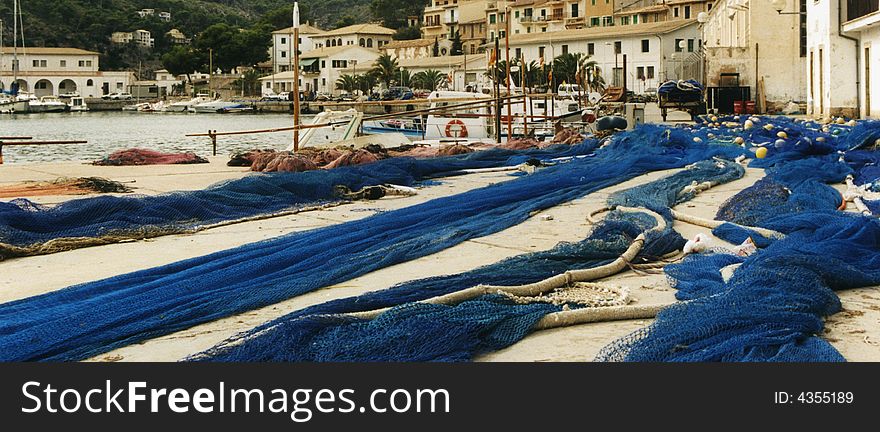 Blue fishing nets lying at the harbor