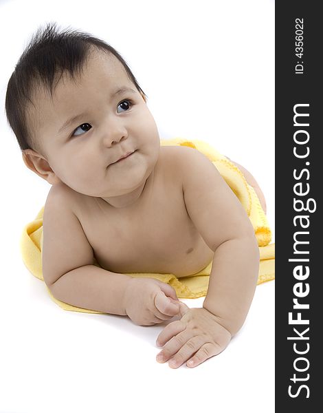 Charming baby with yellow soft cover before white background