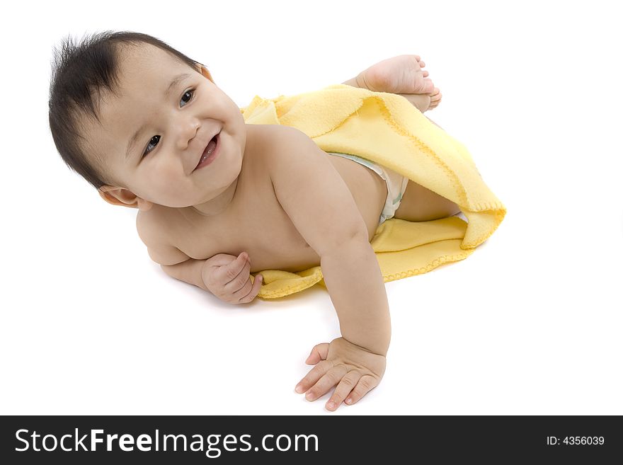 Charming baby with yellow soft cover before white background