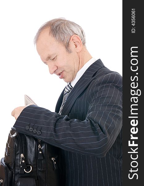 The adult businessman with a bag isolated on a white background. The adult businessman with a bag isolated on a white background