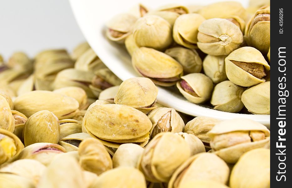 Pistachios from bowl background, close-up