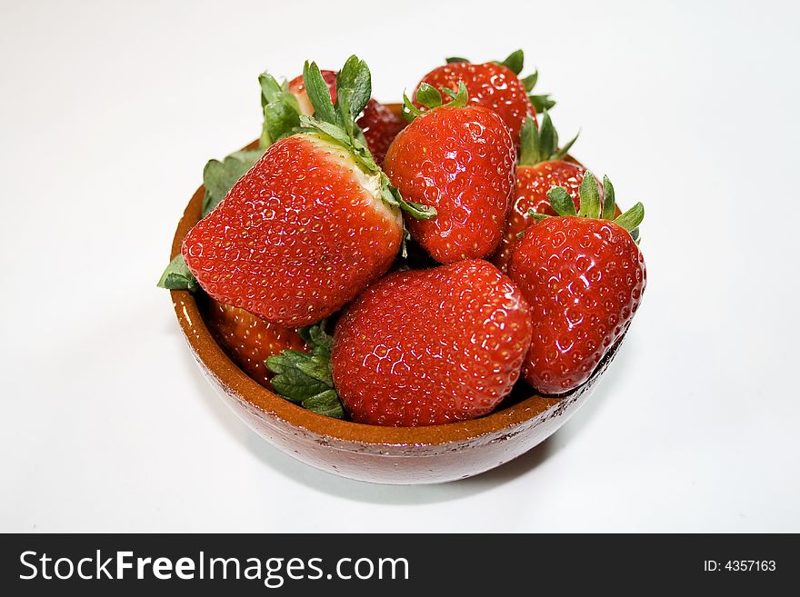 Bowl of strawberries on white background