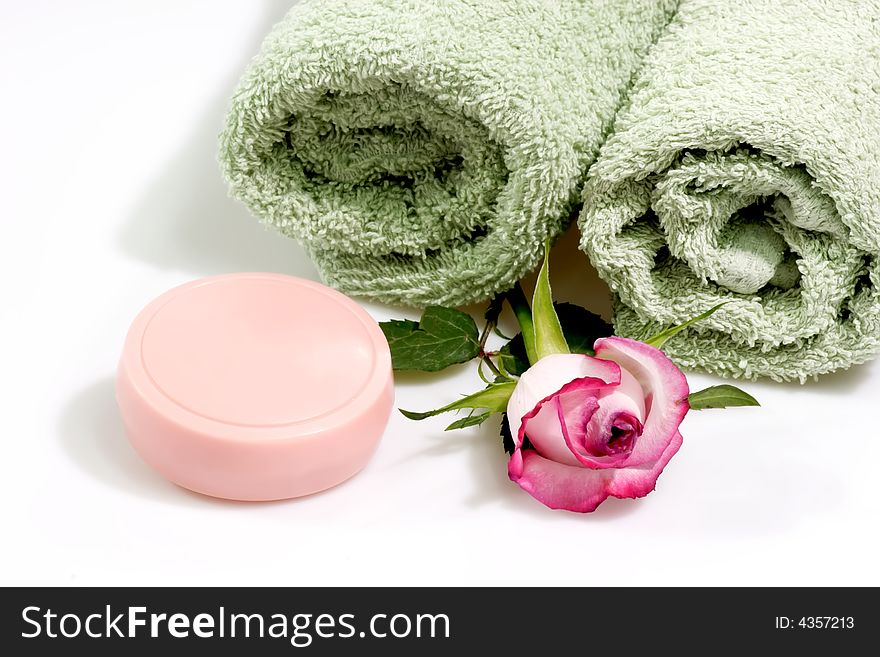 Towel and soap on a bright background. Towel and soap on a bright background