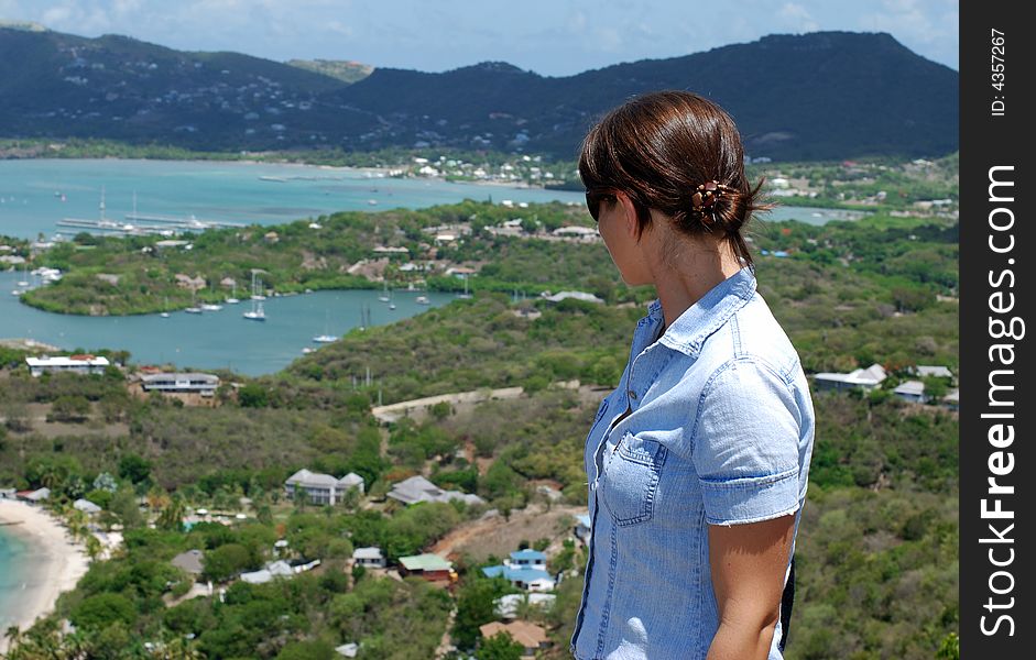 The girl is looking at Nelson's Bay on Antigua island.