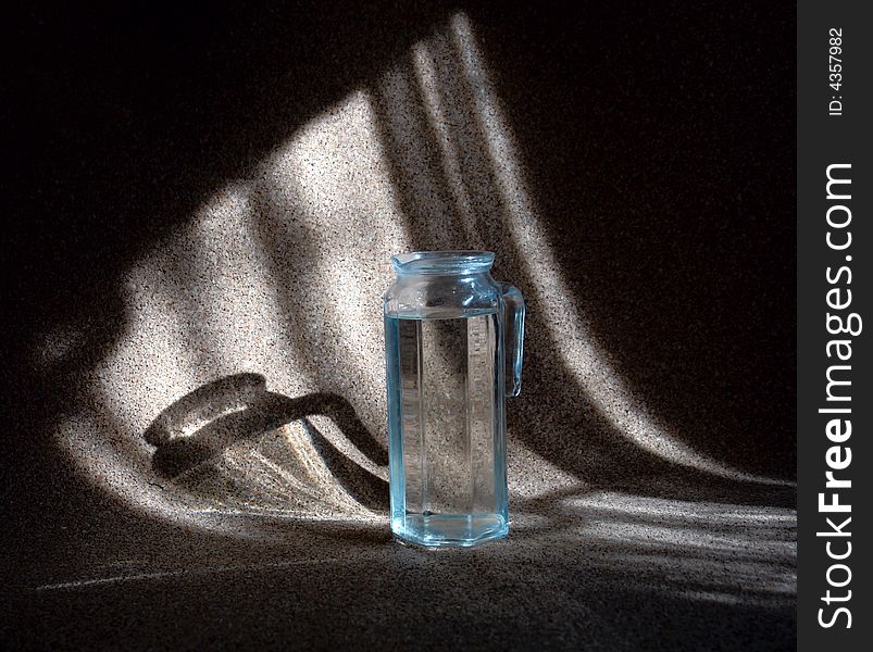 Photo of the carafe with water at the dark background