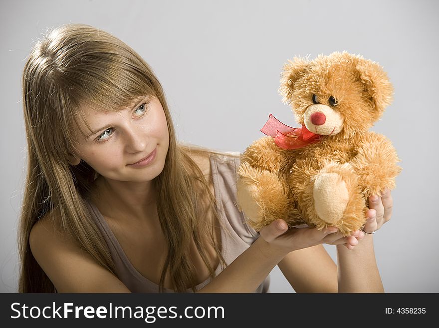 Beautiful young girl holding a teddy bear toy. Beautiful young girl holding a teddy bear toy