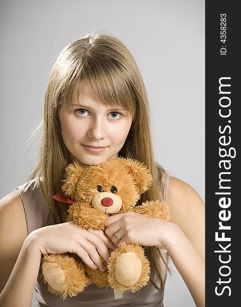Beautiful young girl holding a teddy bear toy. Beautiful young girl holding a teddy bear toy