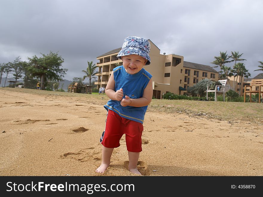 Little boy on sandy beach , holiday