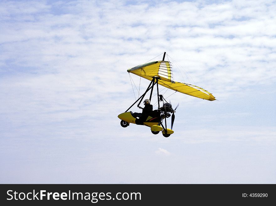 Sideview of an ultralight aircraft against a blue sky. Sideview of an ultralight aircraft against a blue sky