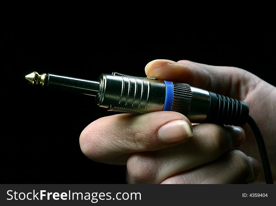 Woman hand holding two jacks on black. Woman hand holding two jacks on black