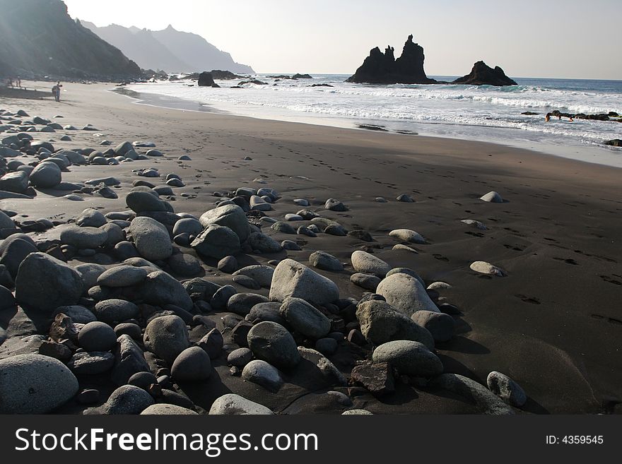 Stone coast with black sand. Stone coast with black sand