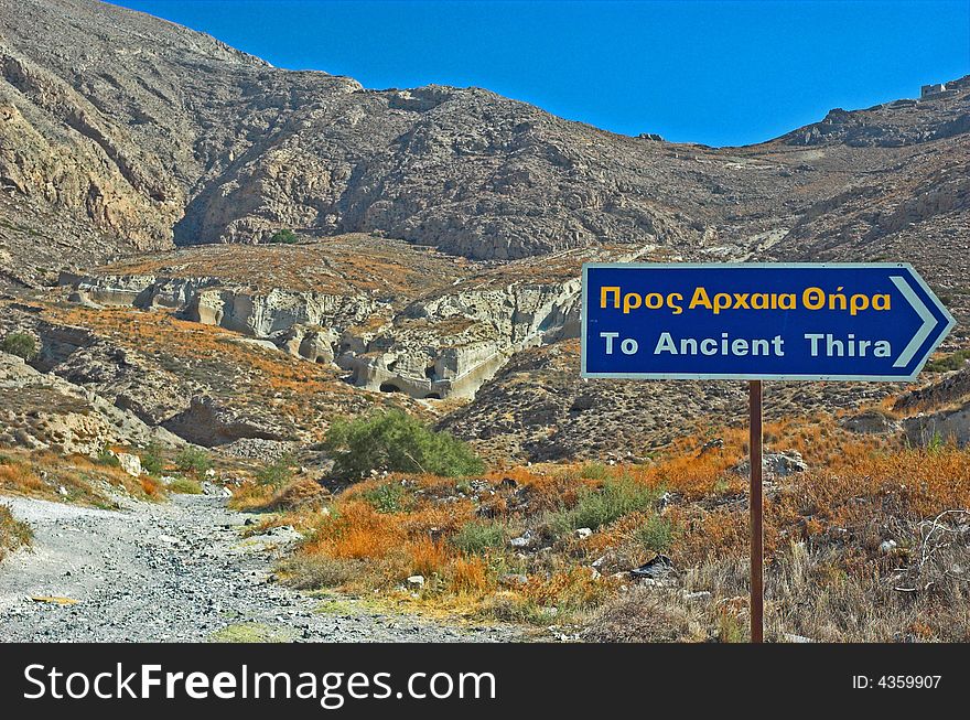 A sign for Ancient Thira in sunny Santorini
