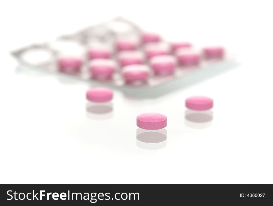 Many tablets lay in a number on a white background