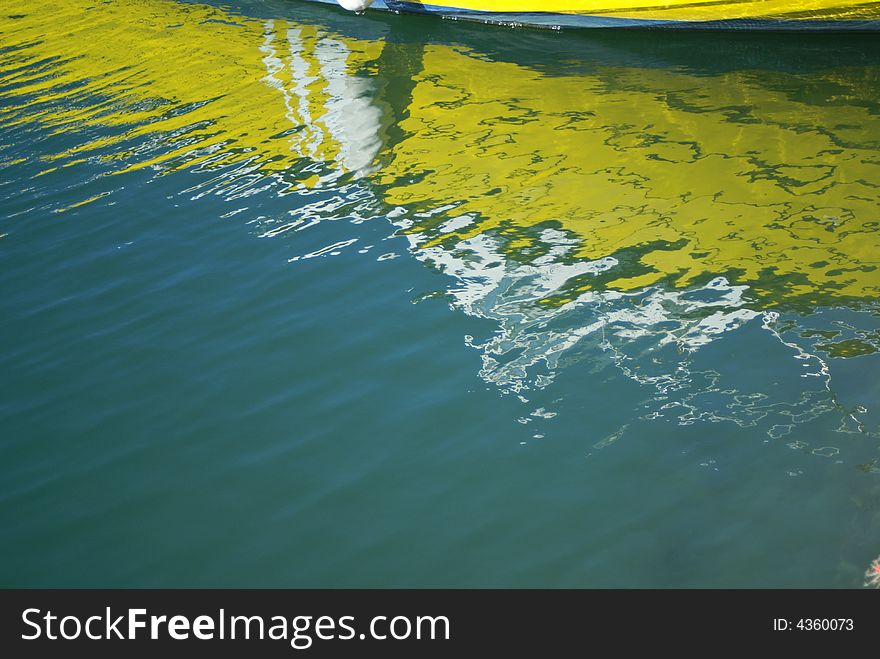 Yellow boat reflections in a port. Yellow boat reflections in a port