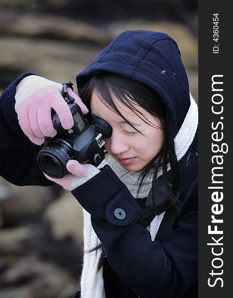 A woman photographer focusing on her subject. A woman photographer focusing on her subject