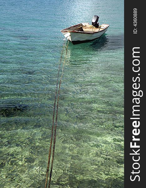 Old fishingboat on shallow water on Bonaire. Old fishingboat on shallow water on Bonaire