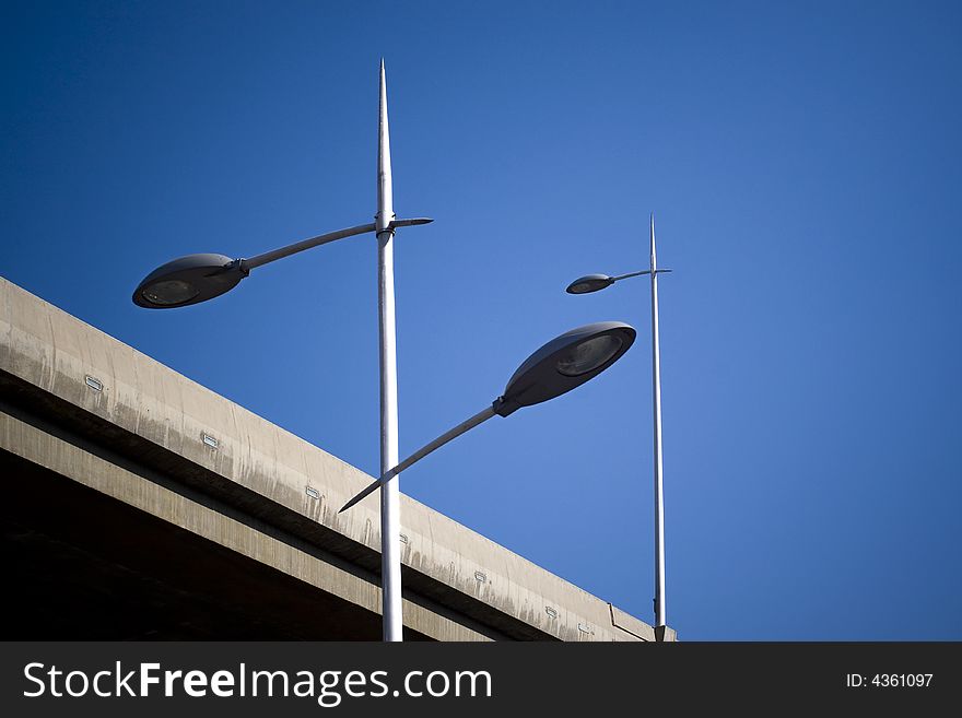 The straight street lamps are under the blue sky.It brings you a mysterious feeling.