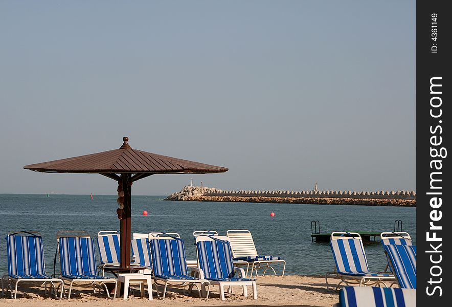 A beach umbrella on the sand by the seaside