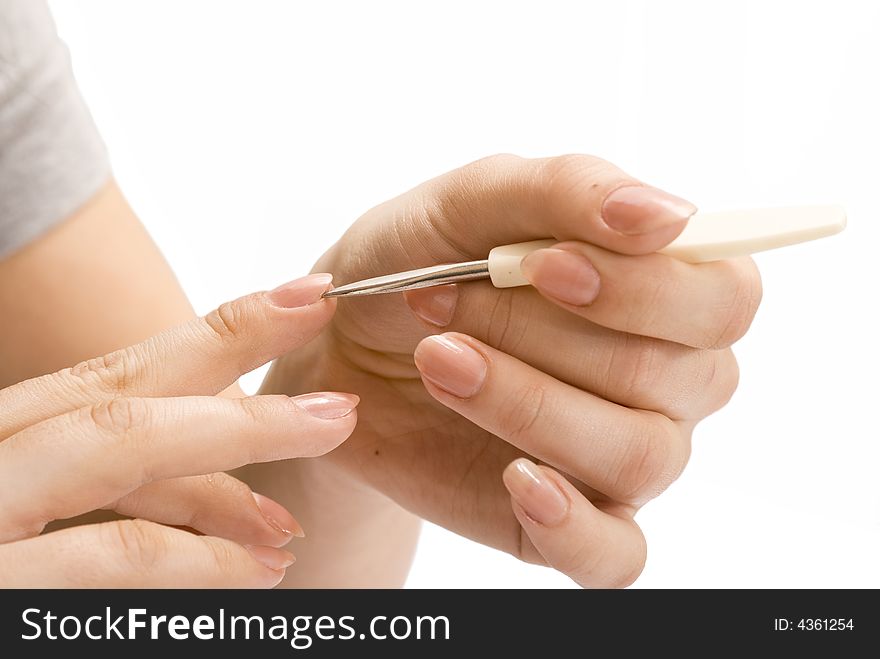 Young girl cleaning her fingernails. Young girl cleaning her fingernails