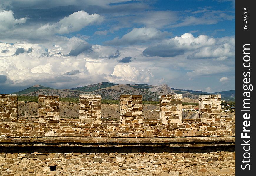 Stone wall and clouds