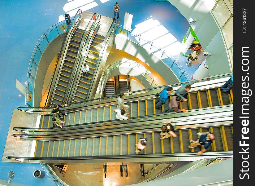 Escalators moving up and down in all directions at all levels in a modern high rise mall