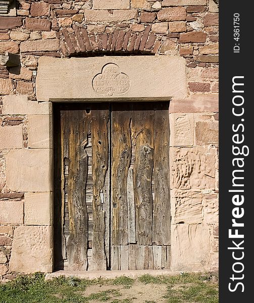 Weathered wooden door on an ancient house. Weathered wooden door on an ancient house