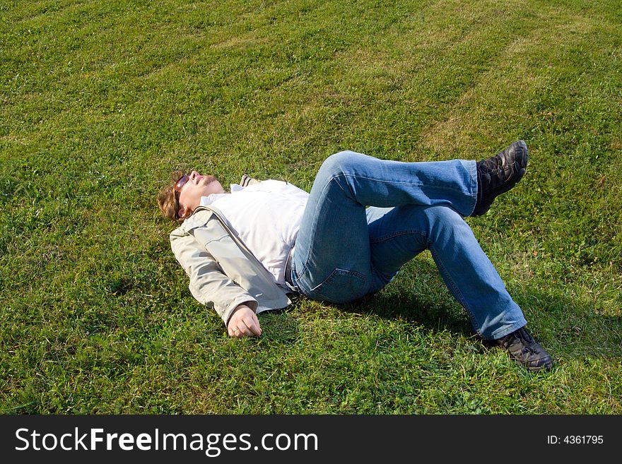 Man relaxing at sunny day at grass