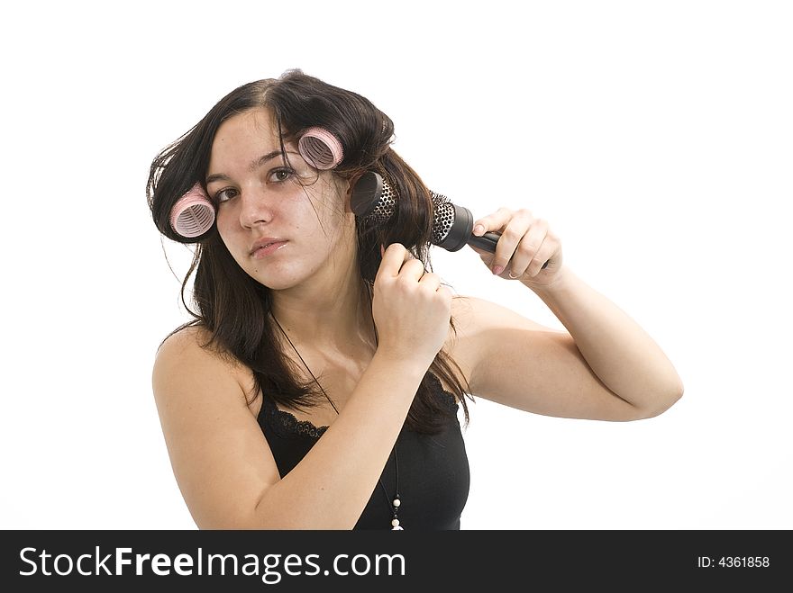 Young girl is brushing her hair. Young girl is brushing her hair