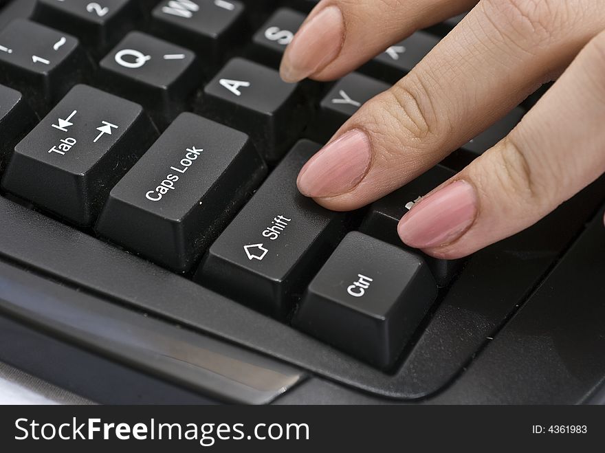 Woman pressing shift button on her keyboard
