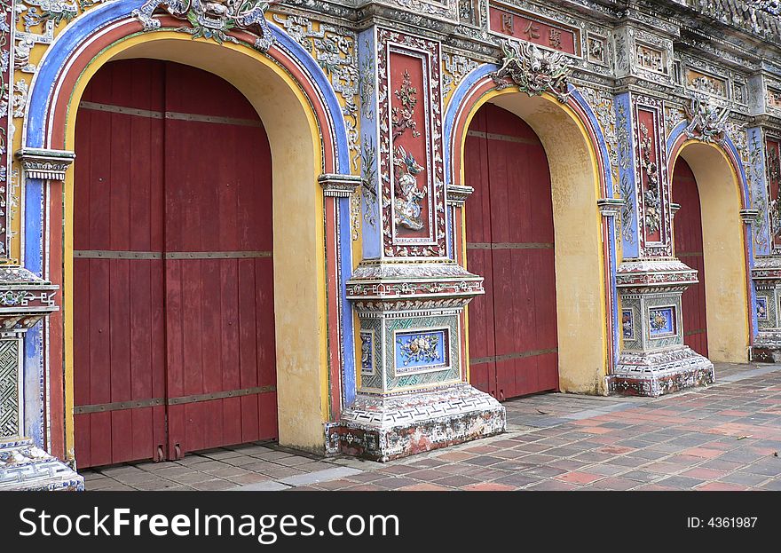 Three red asian doors set in commemorative asian wall. Three red asian doors set in commemorative asian wall