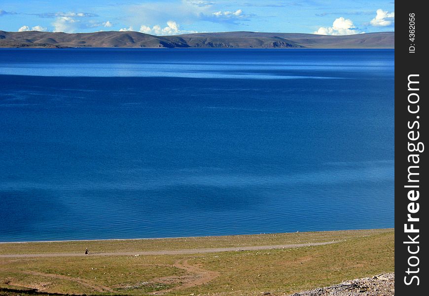 This photo is the scene of Namsto lake, Tibet, China. This lake is a holy site in Tibet buddhism tales. It's the the world's highest lake at an Altitude of about 4,700 metres (15,420 feet).