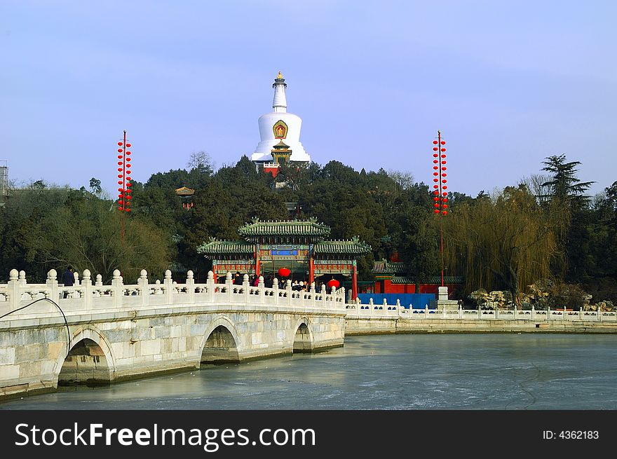 The park of the North Sea of the winter is in Peking, white tower and stone bridge