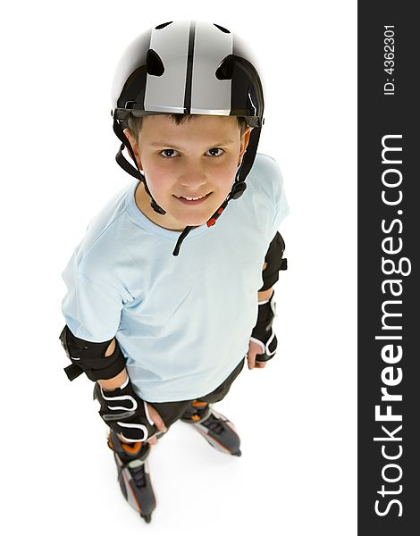 Young, happy roller boy in protection kit standing and looking at camera. High angle view. Isolated on white background. Young, happy roller boy in protection kit standing and looking at camera. High angle view. Isolated on white background.