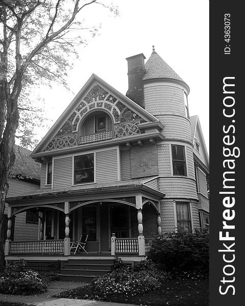 Black and white of the front of an older looking house. Black and white of the front of an older looking house