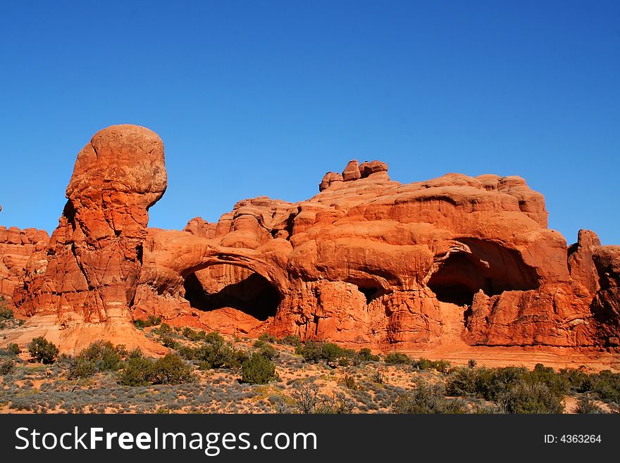 View of the red rock formations in Arches National Park with blue skys. View of the red rock formations in Arches National Park with blue skys