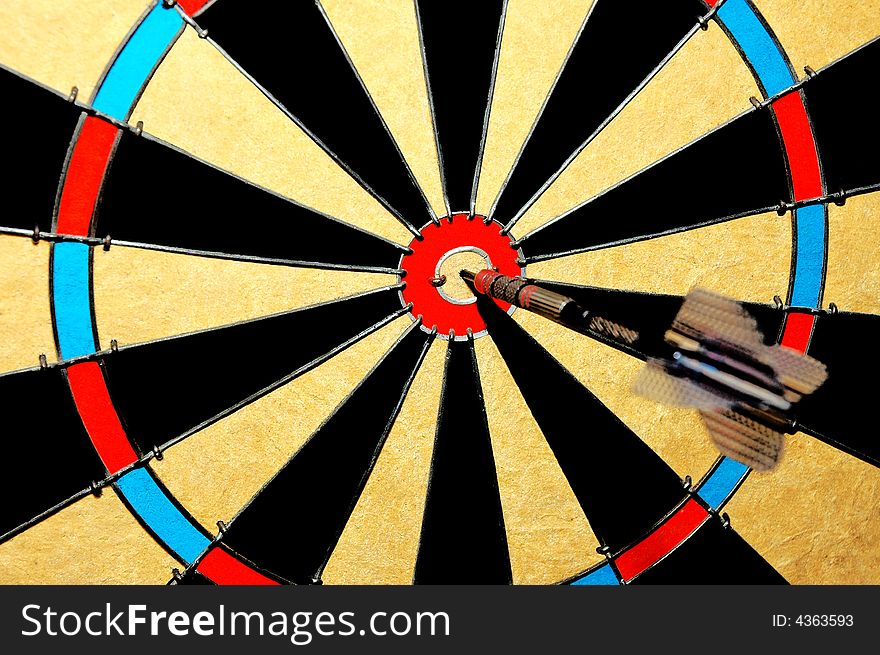 Hitting the bullseye ina game of darts. Hitting the bullseye ina game of darts.