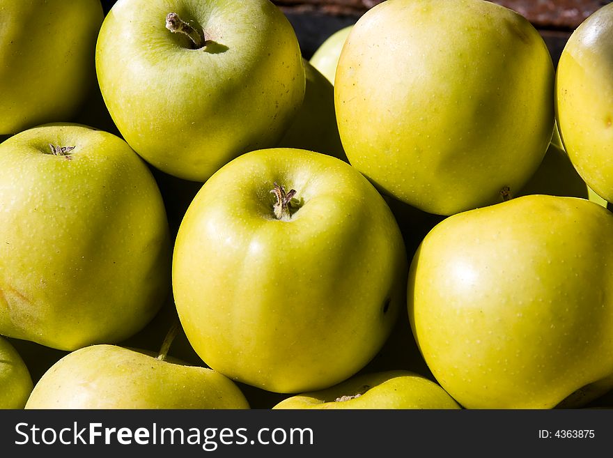 Green apples on the marketplace macro on the sunlight