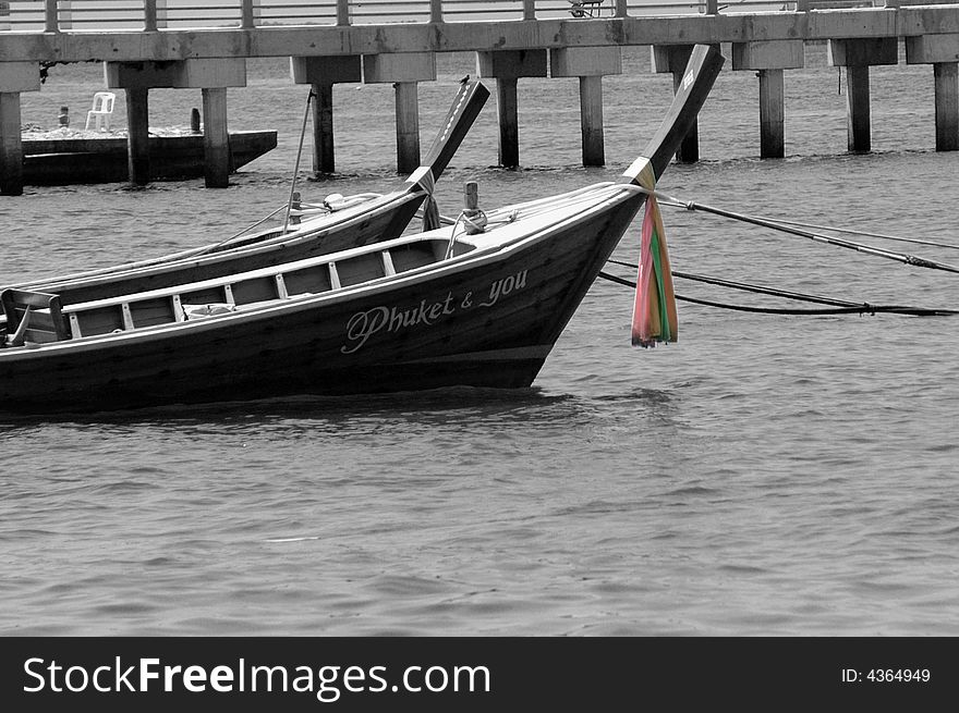 Thai boat in black and white with the prayer cloth in colour and wrapped around the neck of the boat. Thai boat in black and white with the prayer cloth in colour and wrapped around the neck of the boat.