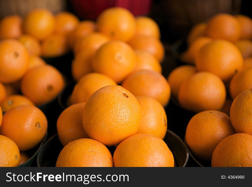 Fresh Oranges for sale in a basket on a open air market stall