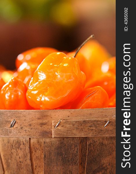 Habanero peppers for sale in a basket on a open air market stall