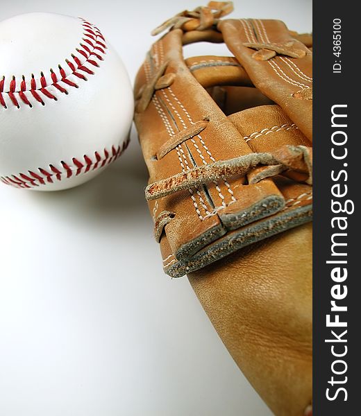 Macro shot of a baseball and mitt with a white background. Macro shot of a baseball and mitt with a white background