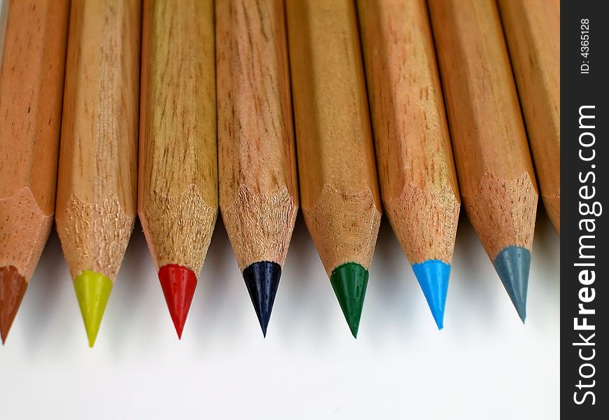 Macro shot of sharpened, natural wood colored pencils with shavings. Macro shot of sharpened, natural wood colored pencils with shavings