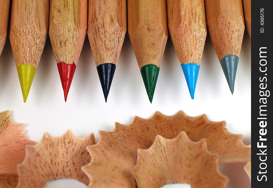 Macro shot of sharpened, natural wood colored pencils with shavings. Macro shot of sharpened, natural wood colored pencils with shavings