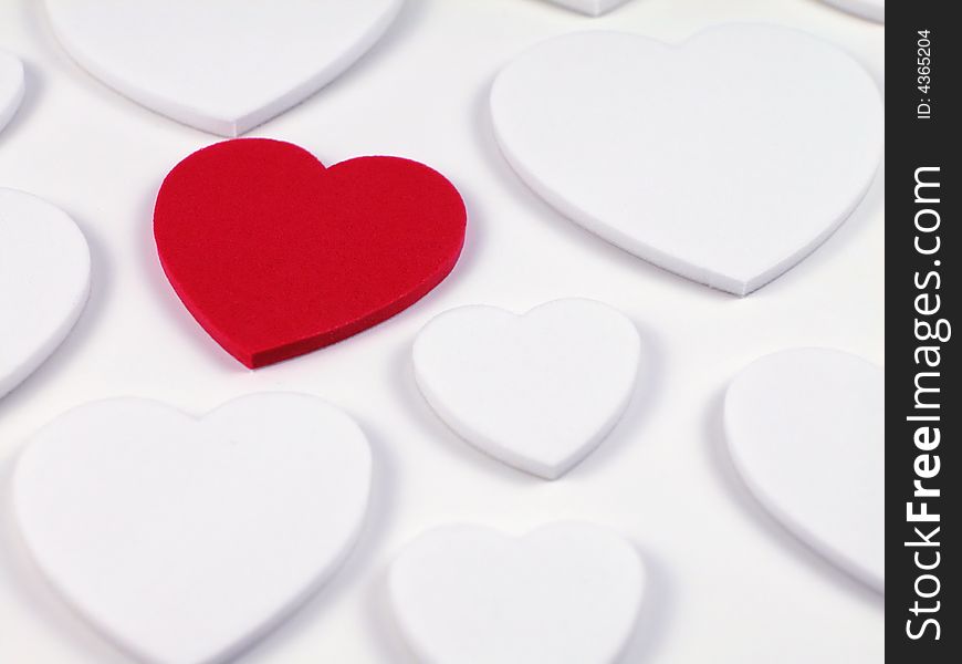Soft focus shot of a single racy red heart surrounded by plain white hearts, great as a valentines background. Soft focus shot of a single racy red heart surrounded by plain white hearts, great as a valentines background
