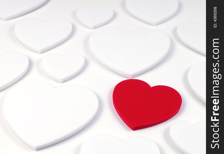 Soft focus shot of a single racy red heart surrounded by plain white hearts, great as a valentines background. Soft focus shot of a single racy red heart surrounded by plain white hearts, great as a valentines background