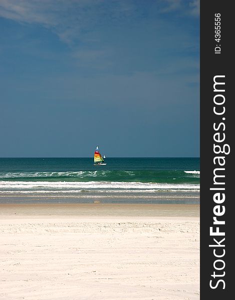 A Hobie Cat catamaran sailing near the beach in Ponce Inlet, Florida. A Hobie Cat catamaran sailing near the beach in Ponce Inlet, Florida.