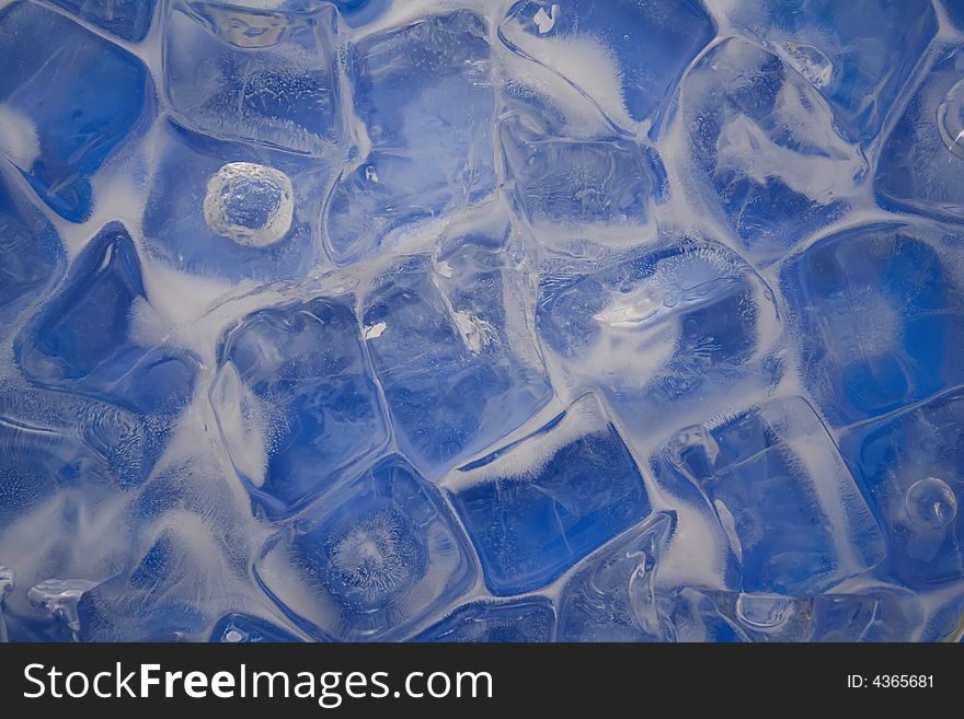 Frozen ice cubes on a blue background