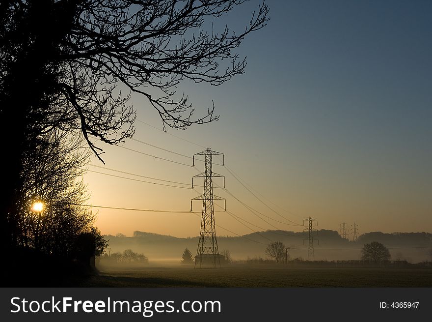 Early morning over a pylon in the countryside