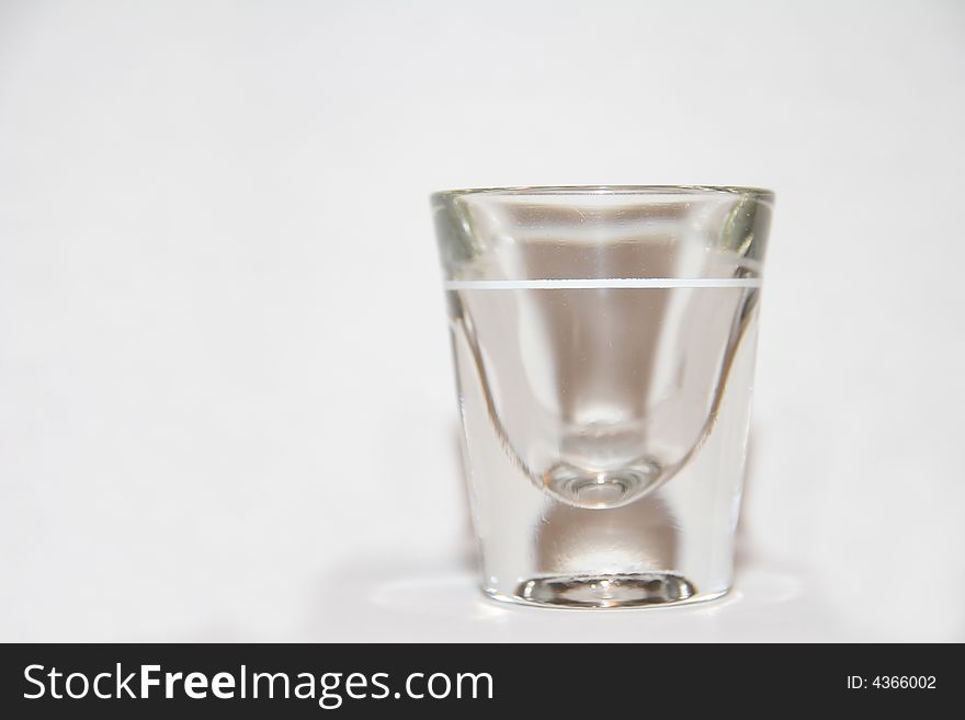 Shot Glass with white background and slight reflection at base